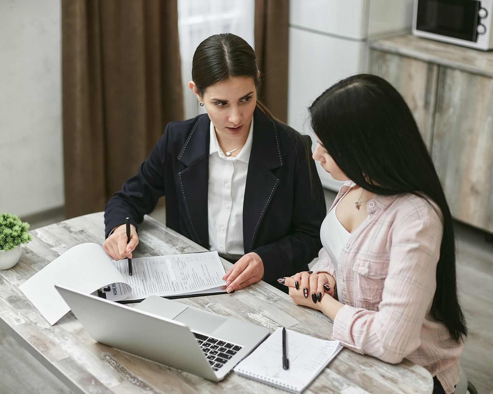 Two people reviewing documents at a desk